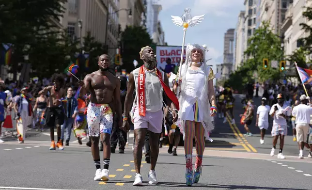 Participants march during the World Pride parade, Saturday, June 7, 2025, in Washington. (AP Photo/Mark Schiefelbein)