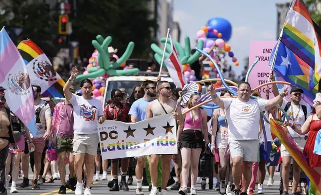 Participants march during the World Pride parade, Saturday, June 7, 2025, in Washington. (AP Photo/Mark Schiefelbein)