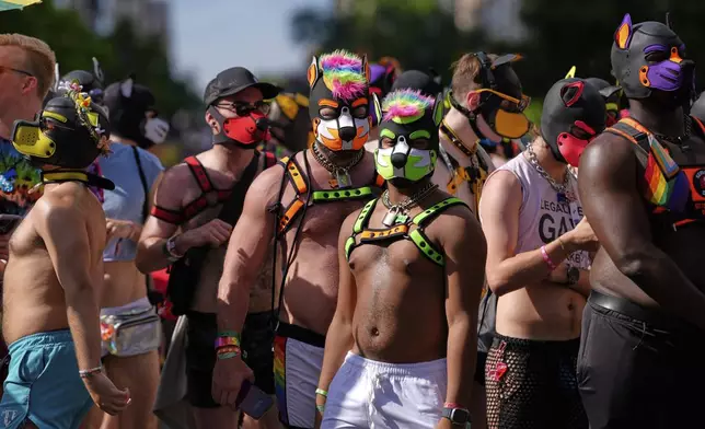 Members of the Tail Wags march during the World Pride Parade, Saturday, June 7, 2025, in Washington. (AP Photo/Mark Schiefelbein)