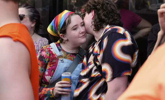 People attend the World Pride parade, Saturday, June 7, 2025, in Washington. (AP Photo/Julia Demaree Nikhinson)