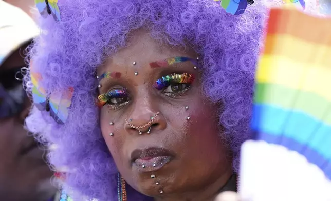 An attendee watches the World Pride parade, Saturday, June 7, 2025, in Washington. (AP Photo/Alex Brandon)