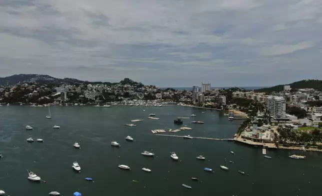 Boats are anchored near Manzanillo beach to be removed from the water ahead of the arrival of Hurricane Erick in Acapulco, Mexico, Wednesday, June 18, 2025. (AP Photo/Fernando Llano)