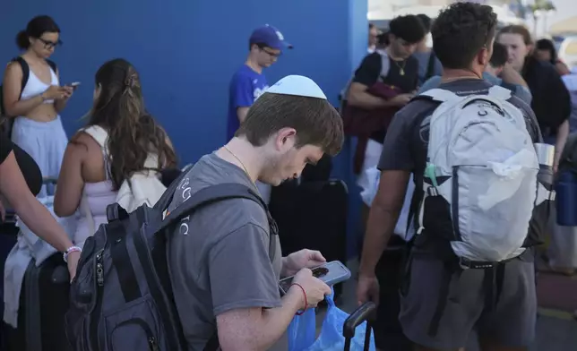 Evacuees from Israel arrive at the port of Larnaca, Cyprus, Wednesday, June 18, 2025. (AP Photo/Petros Karadjias)