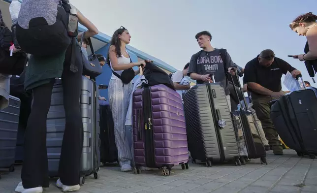 Evacuees from Israel arrive at the port of Larnaca, Cyprus, Wednesday, June 18, 2025. (AP Photo/Petros Karadjias)
