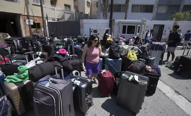 Luggage of evacuees from Israel are seen outside of a Jews community center, after their arrival from Israel to the port of Larnaca, Cyprus, Wednesday, June 18, 2025. (AP Photo/Petros Karadjias)