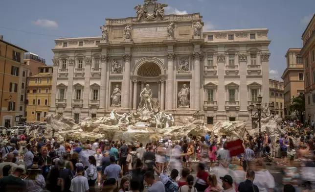 FILE - Tourists visit the Trevi Fountain in Rome, Friday, June 30, 2023. (AP Photo/Andrew Medichini, File)