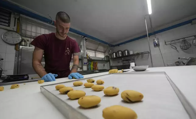 Pastry chef Elias prepares traditionals Zaletti biscuits at the Andrea Rosa Salva pastry kitchen, in Venice, Italy, Thursday, June 12, 2025. (AP Photo/Luca Bruno)