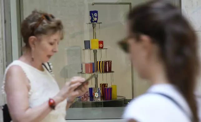 Art glasses are displayed in a shop window of Laguna B glassmaker in Venice, Italy, Thursday, June 12, 2025. (AP Photo/Luca Bruno)