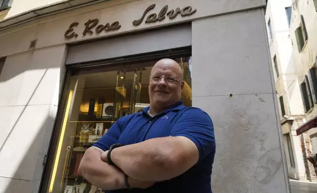 Andrea Rosa Salva pastry shop owner poses outside his shop in Venice, Italy, Thursday, June 12, 2025. (AP Photo/Luca Bruno)