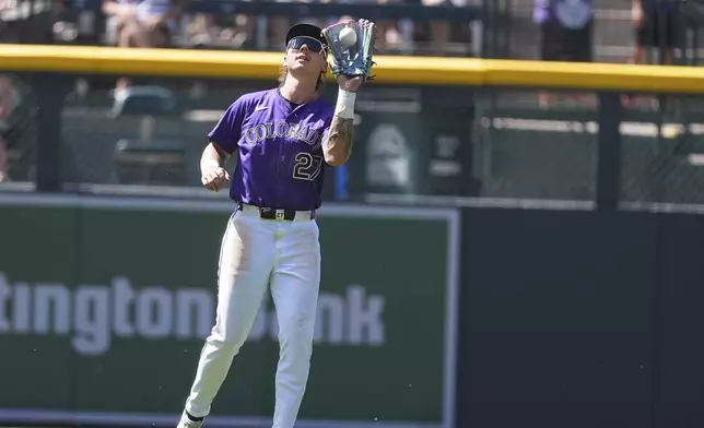 Colorado Rockies left fielder Jordan Beck catches a fly ball off the bat of Arizona Diamondbacks pinch-hitter Ketel Marte to end a baseball game Sunday, June 22, 2025, in Denver. (AP Photo/David Zalubowski)