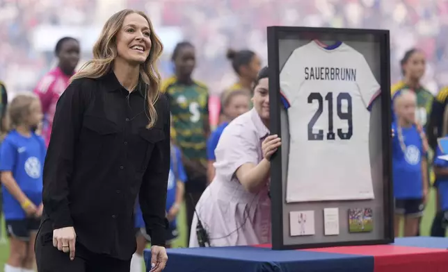 Longtime defender Becky Sauerbrunn, a St. Louis native who retired from soccer late last year, is honored before the start of an international friendly soccer match between the United States and Jamaica Tuesday, June 3, 2025, in St. Louis. (AP Photo/Jeff Roberson)