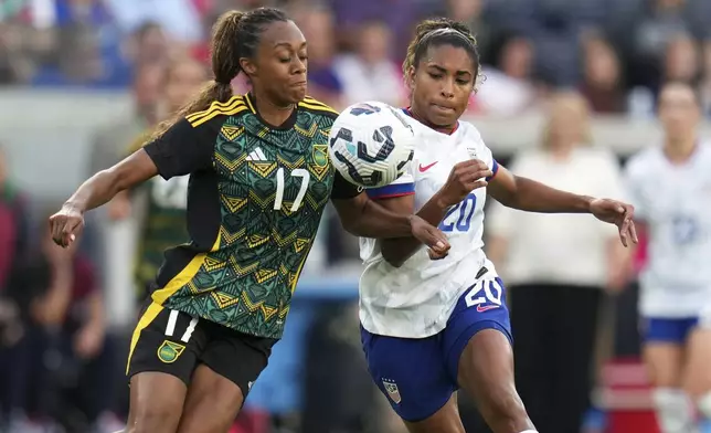 Jamaica's Allyson Swaby (17) and United States' Catarina Macario (20) battle for the ball during the first half of an international friendly soccer match Tuesday, June 3, 2025, in St. Louis. (AP Photo/Jeff Roberson)