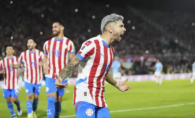 Paraguay's Julio Enciso celebrates scoring his side's second goal against Uruguay during a qualifying soccer match for the FIFA World Cup 2026 in Asuncion, Paraguay, Thursday, June 5, 2025. (AP Photo/Jorge Saenz)