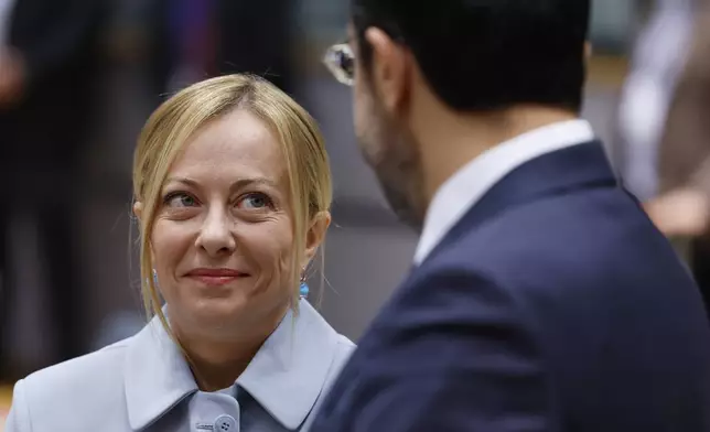Italy's Prime Minister Giorgia Meloni, left, speaks with Cypriot President Nikos Christodoulides during a round table meeting at an EU summit in Brussels, Thursday, June 26, 2025. (AP Photo/Geert Vanden Wijngaert)