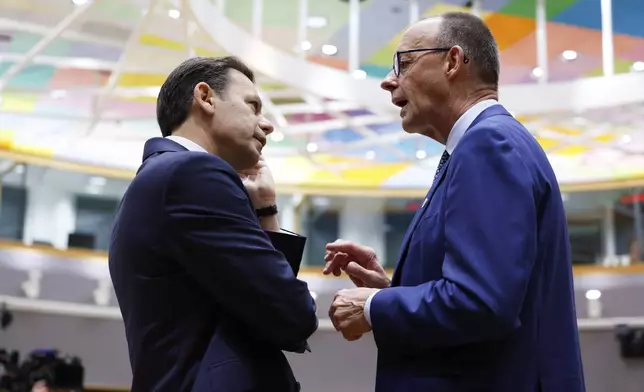 Germany's Chancellor Friedrich Merz, right, speaks with Portugal's Prime Minister Luis Montenegro during a round table meeting at an EU summit in Brussels, Thursday, June 26, 2025. (AP Photo/Geert Vanden Wijngaert)