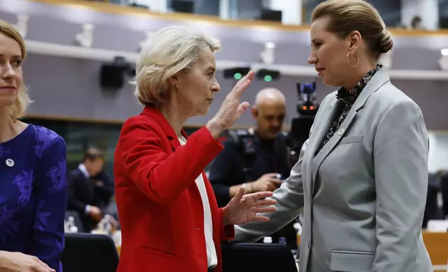 Denmark's Prime Minister Mette Frederiksen, right, speaks with European Commission President Ursula von der Leyen, center, during a round table meeting at an EU summit in Brussels, Thursday, June 26, 2025. (AP Photo/Geert Vanden Wijngaert)