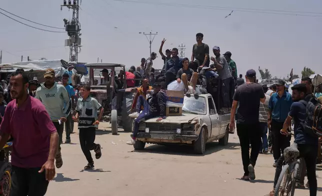 Palestinians carry food and humanitarian aid packages delivered by the Gaza Humanitarian Foundation, a U.S.-backed organization, in Rafah, southern Gaza Strip, Tuesday, June 10, 2025. (AP Photo/Abdel Kareem Hana)