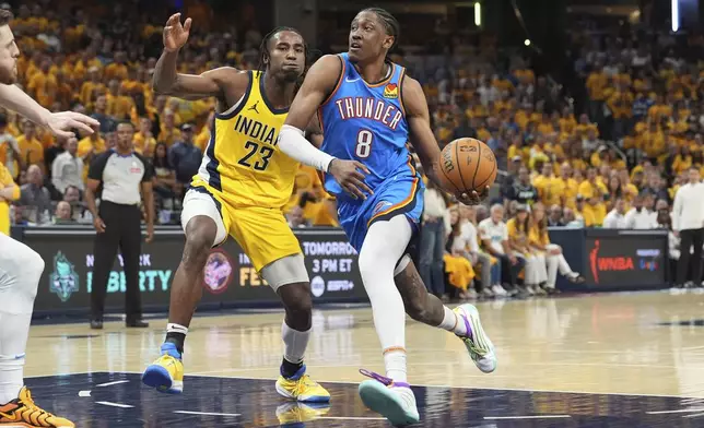 Oklahoma City Thunder forward Jalen Williams (8) drives as Indiana Pacers forward Aaron Nesmith (23) defends during the second half of Game 4 of the NBA Finals basketball series, Friday, June 13, 2025, in Indianapolis. (AP Photo/Michael Conroy)