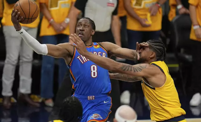 Oklahoma City Thunder forward Jalen Williams (8) shoots around Indiana Pacers guard Tyrese Haliburton during the first half of Game 4 of the NBA Finals basketball series, Friday, June 13, 2025, in Indianapolis. (AP Photo/Abbie Parr)
