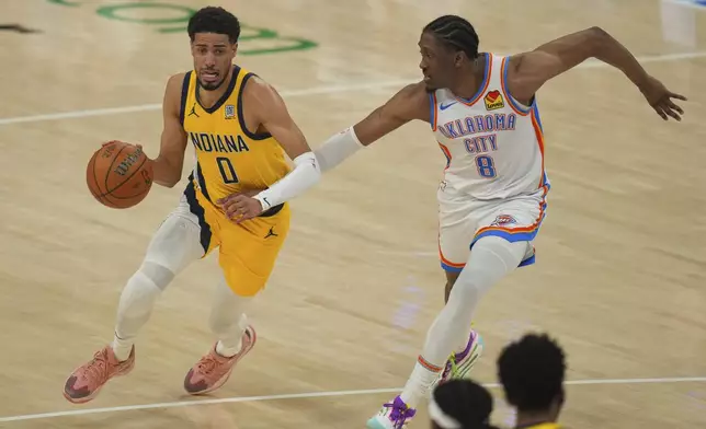 Indiana Pacers guard Tyrese Haliburton (0) drives as Oklahoma City Thunder forward Jalen Williams (8) defends during the first half of Game 5 of the NBA Finals basketball series, Monday, June 16, 2025, in Oklahoma City. (AP Photo/Nate Billings)