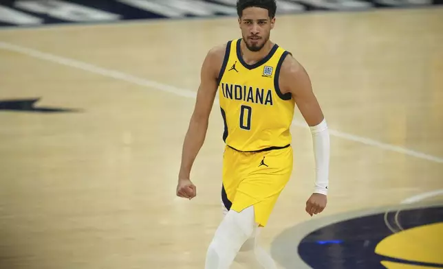 Indiana Pacers guard Tyrese Haliburton looks towards the bench after a basket during the first half of Game 6 of the NBA Finals basketball series against the Oklahoma City Thunder, Thursday, June 19, 2025, in Indianapolis. (AP Photo/Michael Conroy)
