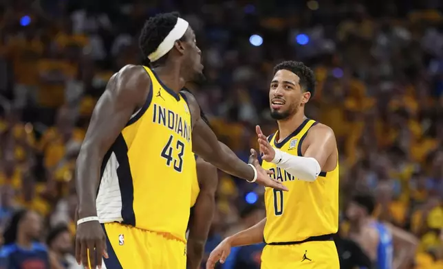 Indiana Pacers guard Tyrese Haliburton (0) celebrates with forward Pascal Siakam (43) during the second half of Game 6 of the NBA Finals basketball series against the Oklahoma City Thunder, Thursday, June 19, 2025, in Indianapolis. (AP Photo/Abbie Parr)