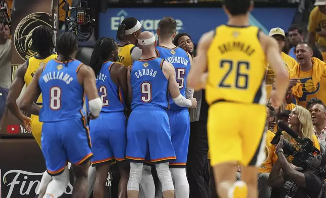Oklahoma City Thunder and Indiana Pacers players are separated by the referees during the first half of Game 4 of the NBA Finals basketball series, Friday, June 13, 2025, in Indianapolis. (AP Photo/Michael Conroy)