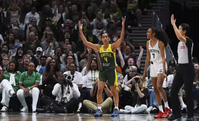 Seattle Storm guard Skylar Diggins (4) reacts after making a three-point basket against New York Liberty guard Rebekah Gardner (7) during the first half of a WNBA basketball game Sunday, June 22, 2025, in Seattle. (AP Photo/Lindsey Wasson)
