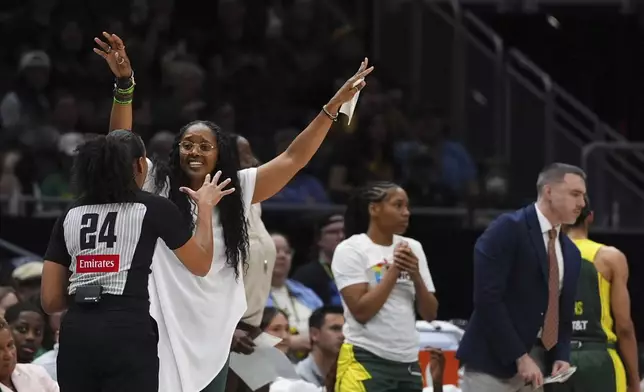 Seattle Storm head coach Noelle Quinn gestures while arguing with an official during the first half of a WNBA basketball game against the New York Liberty, Sunday, June 22, 2025, in Seattle. (AP Photo/Lindsey Wasson)