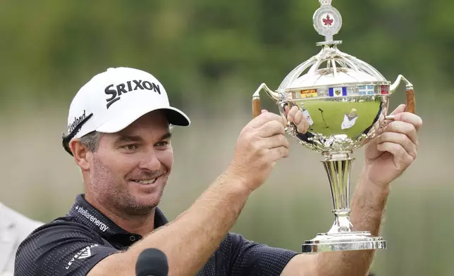 Ryan Fox raises the championship trophy after winning the RBC Canadian Open golf tournament in Caledon, Ontario, Sunday, June 8, 2025. (Frank Gunn/The Canadian Press via AP)