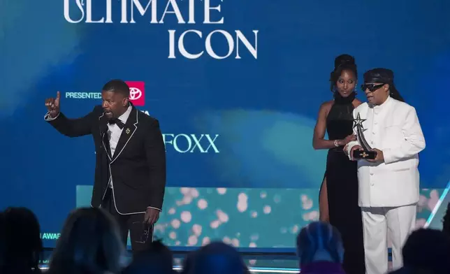 Jamie Foxx accepts the ultimate icon award during the BET Awards on Monday, June 9, 2025, at the Peacock Theater in Los Angeles. Stevie Wonder looks on from right. (AP Photo/Chris Pizzello)