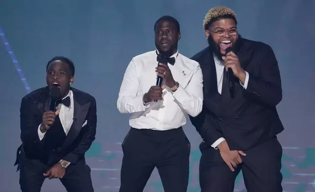 Kai Cenat, from left, Host Kevin Hart and Druski speak during the BET Awards on Monday, June 9, 2025, at the Peacock Theater in Los Angeles. (AP Photo/Chris Pizzello)