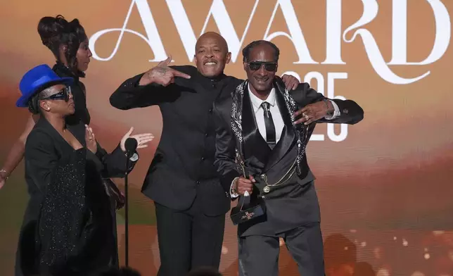 Dr. Dre, center, presents the ultimate icon award to Snoop Dogg during the BET Awards on Monday, June 9, 2025, at the Peacock Theater in Los Angeles. Shante Broadus looks on from left. (AP Photo/Chris Pizzello)
