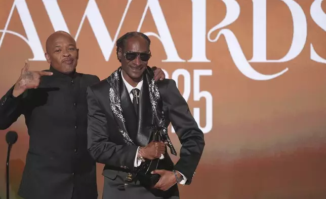 Snoop Dogg, right, accepts the ultimate icon award during the BET Awards on Monday, June 9, 2025, at the Peacock Theater in Los Angeles. Dr. Dre look on from left,(AP Photo/Chris Pizzello)