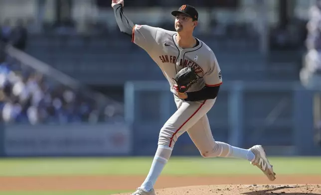 San Francisco Giants pitcher Sean Hjelle throws to a Los Angeles Dodgers batter during the first inning of a baseball game in Los Angeles, Sunday, June 15, 2025. (AP Photo/Jessie Alcheh)