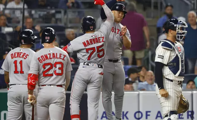 Boston Red Sox's Carlos Narváez (75)celebrates with Rob Refsnyder after hitting a home run against the New York Yankees during the sixth inning of a baseball game, Sunday, June 8, 2025, in New York. (AP Photo/Noah K. Murray)