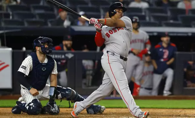 Boston Red Sox designated hitter Rafael Devers (11) follows through on a home run during the ninth inning of a baseball game against the New York Yankees, Sunday, June 8, 2025, in New York. (AP Photo/Noah K. Murray)