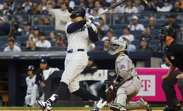 New York Yankees outfielder Aaron Judge (99) follows through on a two run home run against the Boston Red Sox during the first inning of a baseball game, Sunday, June 8, 2025, in New York. (AP Photo/Noah K. Murray)