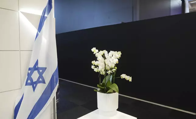 An Israeli flag is seen next to a black wall that blocks the Israeli pavilions erected at the Paris Air Show , Monday, June 16, 2025 in Le Bourget, north of Paris. (AP Photo/Michel Euler)