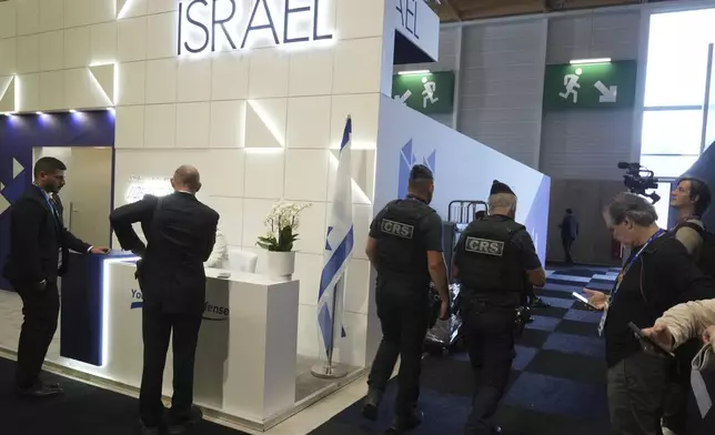 Riot police officers patrol by the Israeli pavilions at the Paris Air Show , Monday, June 16, 2025 in Le Bourget, north of Paris. (AP Photo/Michel Euler)
