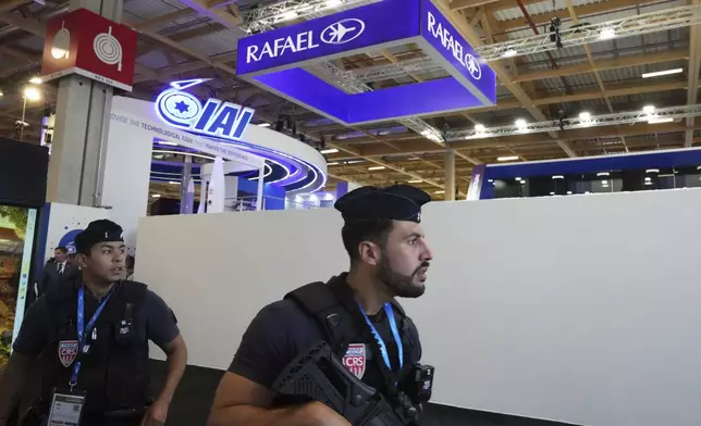 Riot police officers patrol by the blocked Rafael stand and Israeli pavilions at the Paris Air Show , Monday, June 16, 2025 in Le Bourget, north of Paris. (AP Photo/Michel Euler)