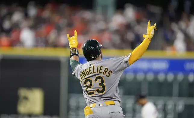 Athletics' Shea Langeliers celebrates after hitting a home run against the Houston Astros during the sixth inning of a baseball game Saturday, July 26, 2025, in Houston. (AP Photo/David J. Phillip)