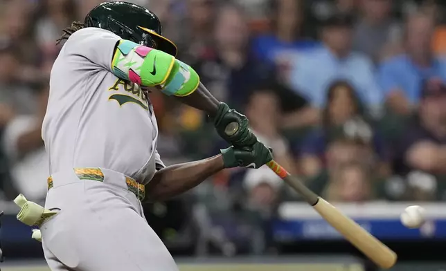 Athletics' Lawrence Butler hits a three-run home run against the Houston Astros during the ninth inning of a baseball game Saturday, July 26, 2025, in Houston. (AP Photo/David J. Phillip)