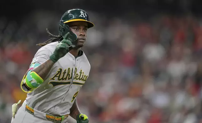 Athletics' Lawrence Butler celebrates after hitting a three-run home run against the Houston Astros during the ninth inning of a baseball game Saturday, July 26, 2025, in Houston. (AP Photo/David J. Phillip)