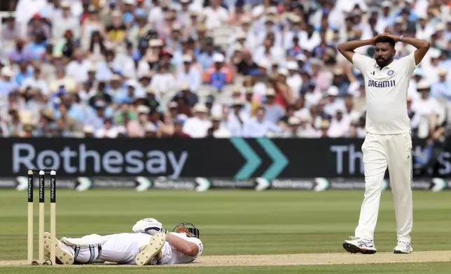 England's captain Ben Stokes lies on ground after a delivery from India's Mohammed Siraj, right, hit him during the fourth day of the third cricket test match between England and India at Lord's cricket ground in London, Sunday, July 13, 2025.(AP Photo/Richard Pelham)