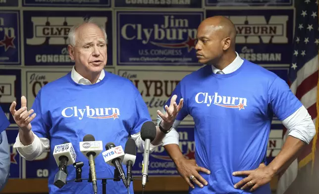 FILE - Minnesota Gov. Tim Walz, left, speaks to reporters as Maryland Gov. Wes Moore looks on at Rep. Jim Clyburn's World Famous Fish, Friday, May 30, 2025, in Columbia, S.C. (AP Photo/Meg Kinnard, File)