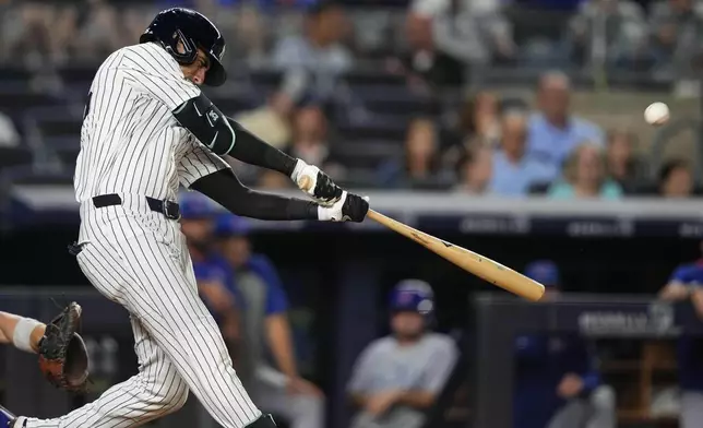New York Yankees' Cody Bellinger hits a home run during the eighth inning of a baseball game against the Chicago Cubs, Friday, July 11, 2025, in New York. (AP Photo/Yuki Iwamura)