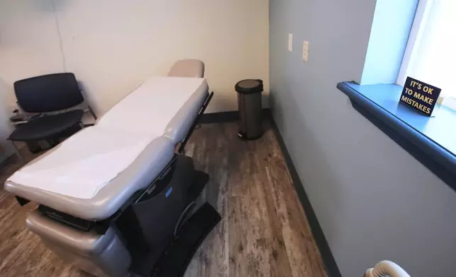 An "It's OK to Make Mistakes" sign rests on a window sill next to an examination table at the Maine Family Planning healthcare facility, July 15, 2025, in Thomaston, Maine. (AP Photo/Charles Krupa)