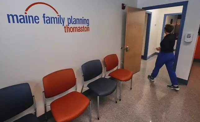 Vanessa Shields-Haas, a nurse practitioner, walks from the lobby toward the examination rooms at the Maine Family Planning healthcare facility, July 15, 2025, in Thomaston, Maine. (AP Photo/Charles Krupa)