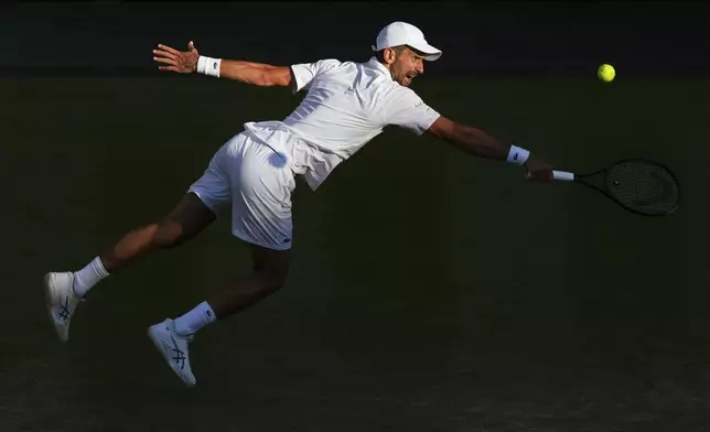 Serbia's Novak Djokovic returns to Italy's Flavio Cobolli during a quarterfinal men's singles match at the Wimbledon Tennis Championships in London, Wednesday, July 9, 2025. (AP Photo/Joanna Chan)